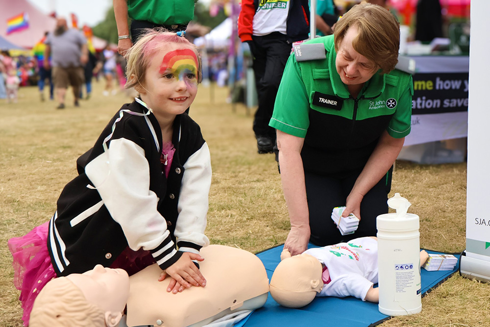 A young girl learning about CPR.
