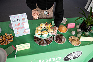 An arrangement of baked treats on a table of a St John Ambulance fundraiser.
