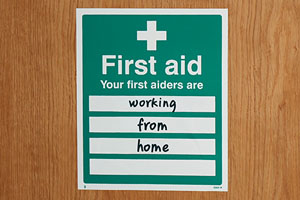 A sign that reads "Your first aiders are working from home".