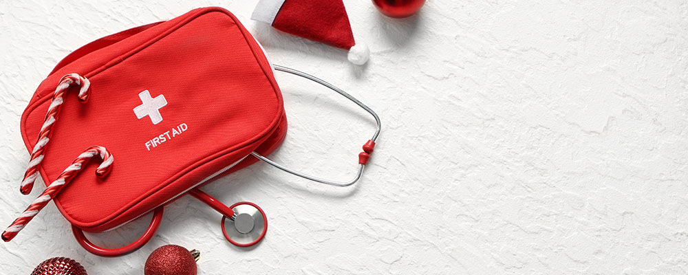 An arrangement of a first aid kit with Christmas decorations.