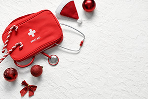 An arrangement of a first aid kit with Christmas decorations.