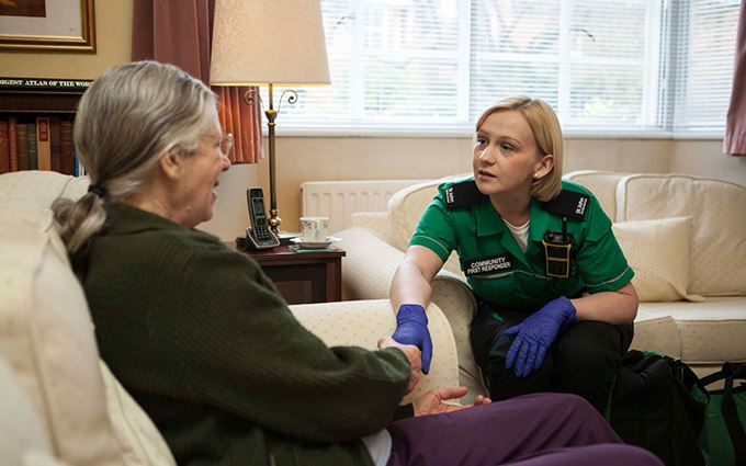 St John Ambulance Community First Responder helping patient