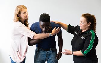 First aid course participants learning how to help someone who is choking