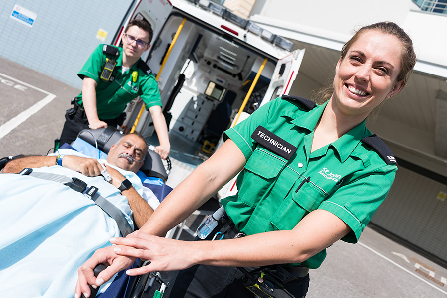 St John Ambulance technicians transporting a patient