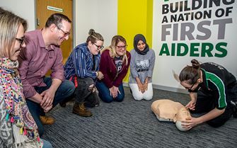 A St John Ambulance first aid trainer teaching CPR A St John Ambulance first aid trainer teaching CPR