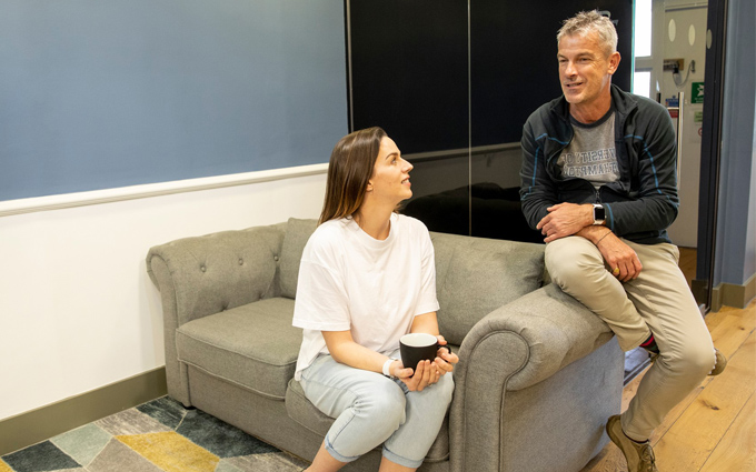 Woman and Man say on the Sofa talking.