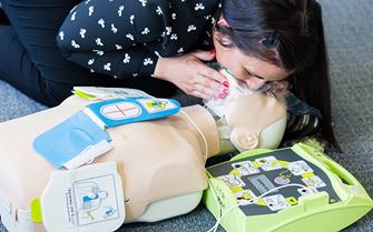 Class participant practices resuscitation using a training mannequin. Class participant practices resuscitation using a training mannequin.